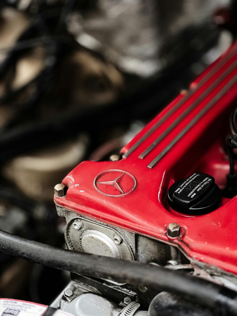 Detailed view of a red Mercedes-Benz engine component showcasing its intricate design.